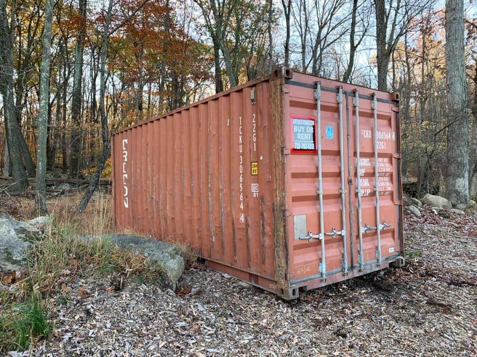 orange storage container in the woods